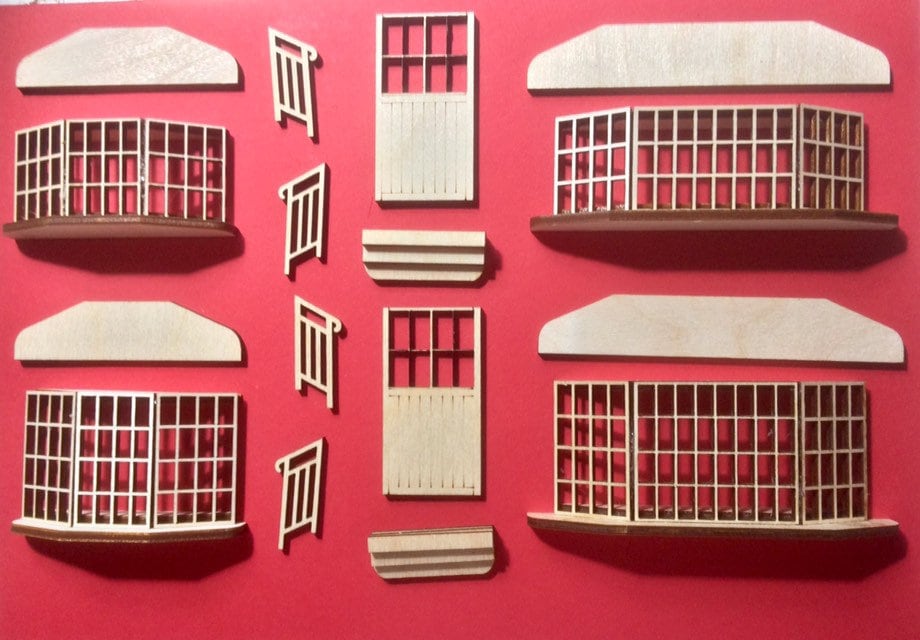 A set of miniature bay windows with window sills, doors with steps and hand rails to add to your diorama project